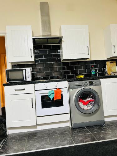 una cocina con lavadora y microondas en Sunnydale Homes, en Rotherham