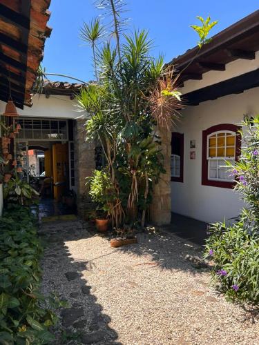 a house with a bunch of plants in front of it at Pousada Solar do Algarve in Paraty