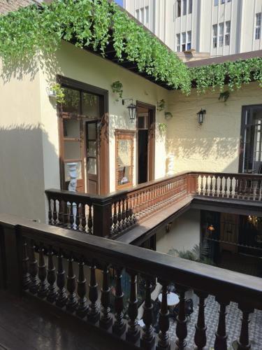 a balcony of a building with a wooden railing at Ancestral Lima Downtown in Lima