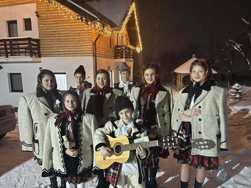 a group of people posing for a picture with a guitar at Maramures Landscape in Moisei
