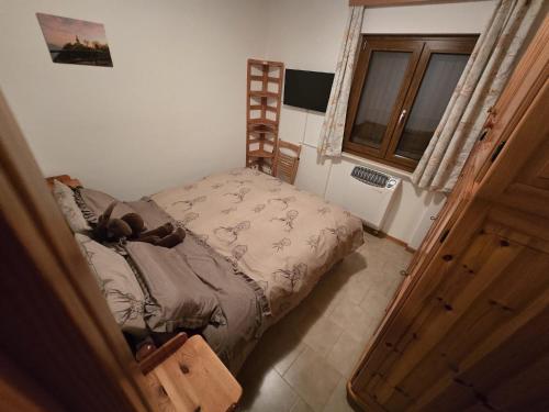 Ένα ή περισσότερα κρεβάτια σε δωμάτιο στο Rifugio Dei Caprioli