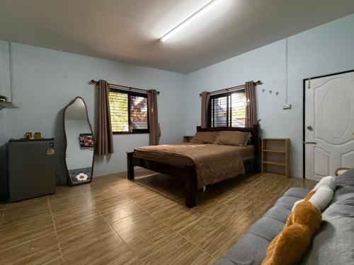 a bedroom with a bed and a mirror in it at Krabi Bloom House in Ban Khlong Khamao (2)