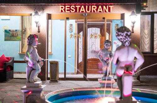 a group of people standing around a swimming pool at Amsterdam Hotel Aktobe in Aktobe