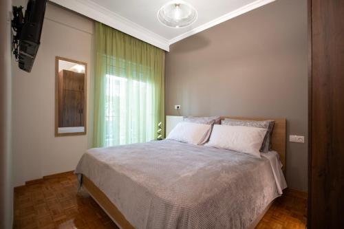 a bedroom with a large bed with a window at Casa Aphrodite Thessaloniki in Thessaloniki