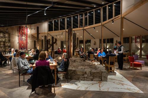 a group of people sitting at tables in a restaurant at Hotel Rosario Uyuni Collection in Uyuni