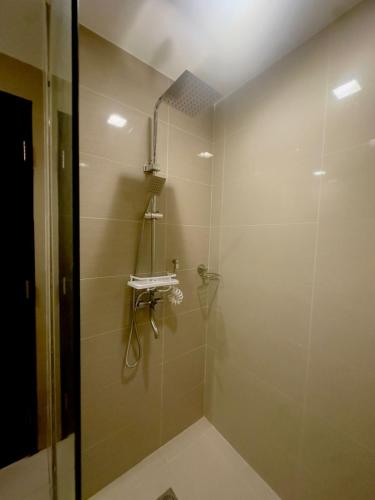 a bathroom with a shower with a glass door at Modern 1 bedroom spacious apartment with Venice Grand Canal View in Manila