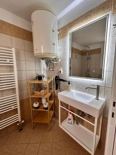 a bathroom with a sink and a mirror at 27 Urban Stay in Neochorópoulon