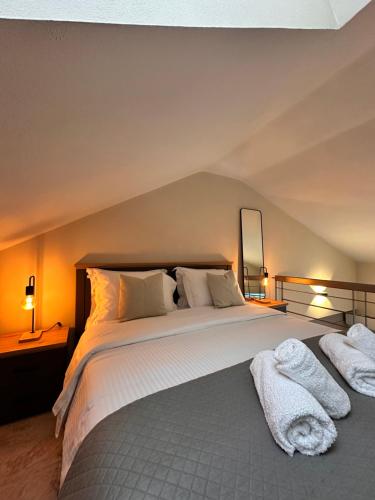 a bedroom with a large bed with towels on it at 27 Urban Stay in Neochorópoulon