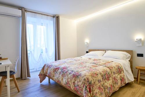 a bedroom with a bed and a large window at Casa Vacanze Nonna Bambina in Palena