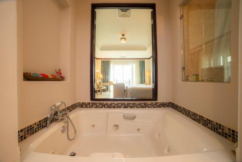 a bath tub in a bathroom with a large mirror at Vista Bahia 3C - 3bdr 3 bath ocean View in La Mona
