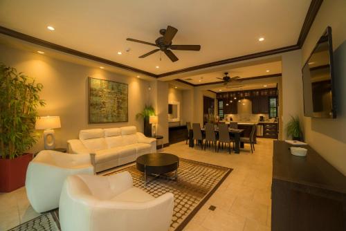 a living room with white furniture and a ceiling fan at Vista Bahia 3D - 3bdr 3bath plunge pool in La Mona