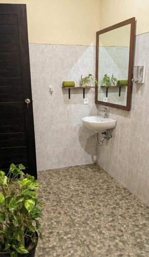 a bathroom with a sink and a mirror at Room #5 Mari Posa Cottage in Badung