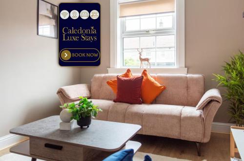 a living room with a couch and a table at Airth House in Airth