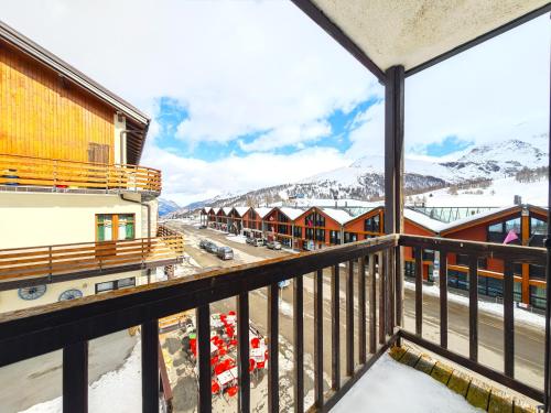 a balcony with a view of a snow covered mountain at Hostdomus - Fox Suite in Sestriere