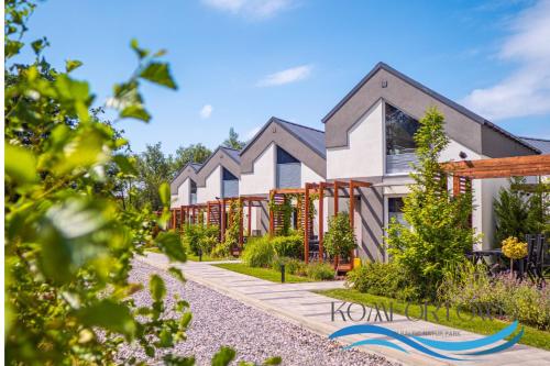 a house with a garden in front of it at Domek w Baltic Natur Park Komfortowy 2 sypialnie klima alpaki mnóstwo atrakcji by DG in Niechorze