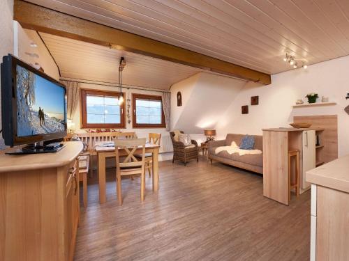 a living room with a television and a dining room at Kirchlehof in Oberried