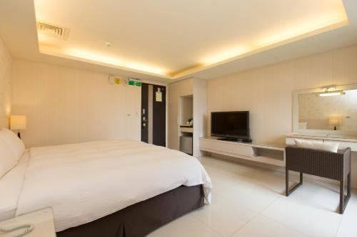 Llit o llits en una habitació de F Hotel - Sanyi