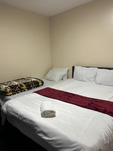 a bedroom with two beds with a leopard blanket at Romantic Guest Rooms in London
