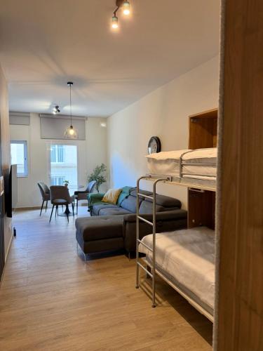 a room with two bunk beds and a dining room at Modern Designer Stay near Sliema Seafront in Il-Gżira