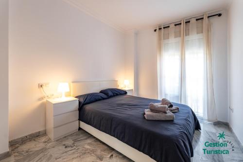 Ένα ή περισσότερα κρεβάτια σε δωμάτιο στο Apartamento moderno en el centro de Huelva