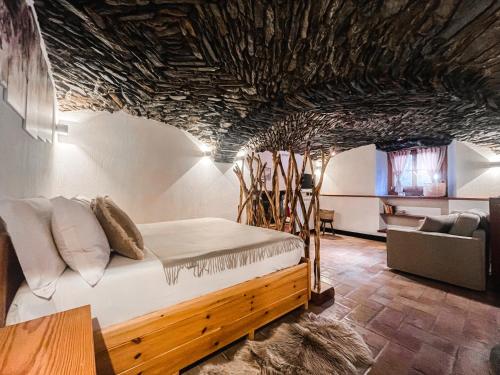 una habitación con una cama y un sofá y una mesa en La Volta di Champoluc - Poluc Apartments Monolocale, en Champoluc