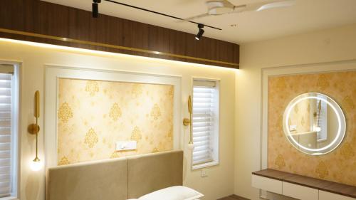 a bathroom with a large mirror and a sink at Kumaran Grand - Luxury Rooms in Madurai