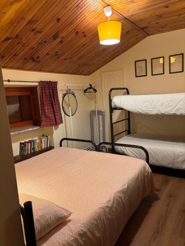 two bunk beds in a room with a wooden ceiling at al Profilo di Napoleone in San Bartolomeo