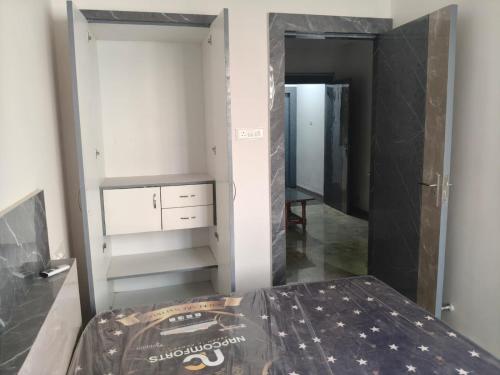 een kamer met een bed en een kast met een spiegel bij Aarav Home in Indore