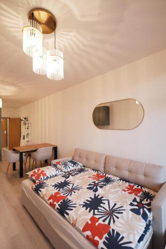 a bedroom with a bed and a dining room at Homey 610 Apartment in Komárov