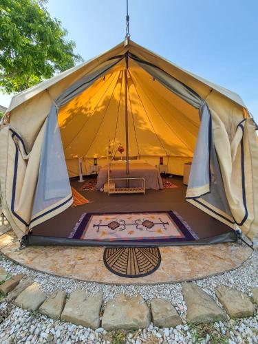 a large tent with a mat in the middle at Glamping & country house Marche Nascoste Gualdo in San Girolamo di Sopra
