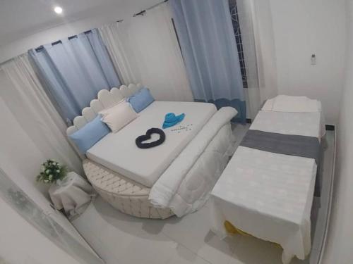 a small bedroom with a white bed at Malaika White House Apartment & Spa in Kiwengwa