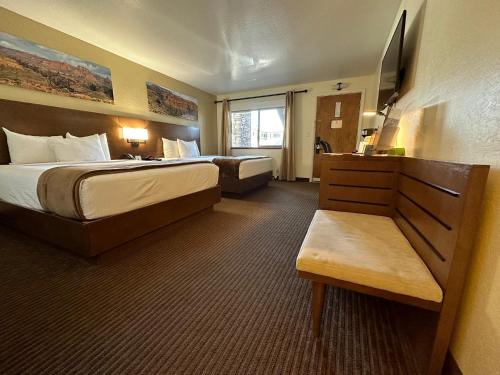 a hotel room with a bed and a couch at Red Feather Lodge/Hotel in Tusayan