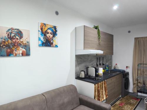 a living room with a couch and a kitchen at Garibaldi guest house in Catania