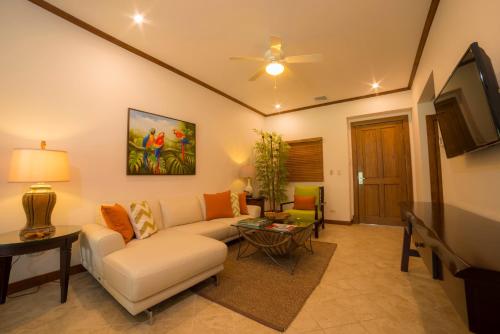 a living room with a couch and a tv at Veranda 8F - 2 bdr 2 bath - Condo in Isla Herradura