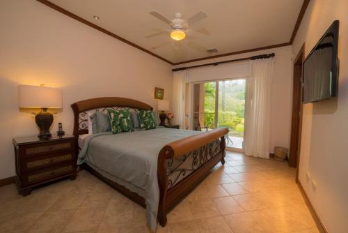 a bedroom with a bed and a tv and a window at Veranda 8F - 2 bdr 2 bath - Condo in Isla Herradura