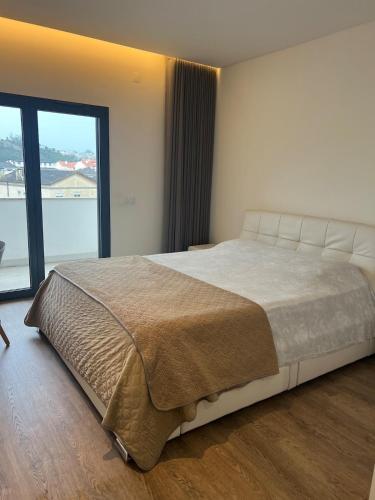 En eller flere senge i et værelse på Apartamento T2 - Leiria