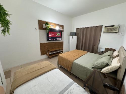a bedroom with a bed and a tv in it at Apartamento Centro Manaus 721 in Manaus