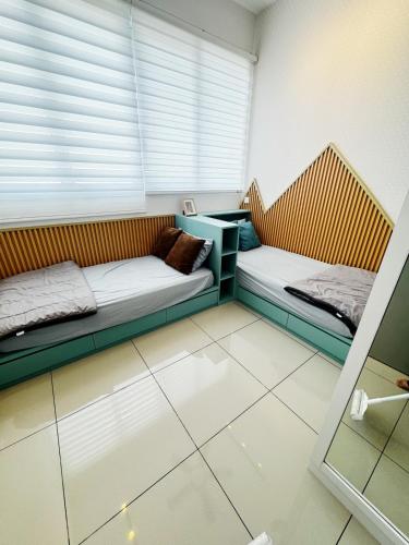 two beds sitting in a room with a window at Palmyra residence New condo in Kajang
