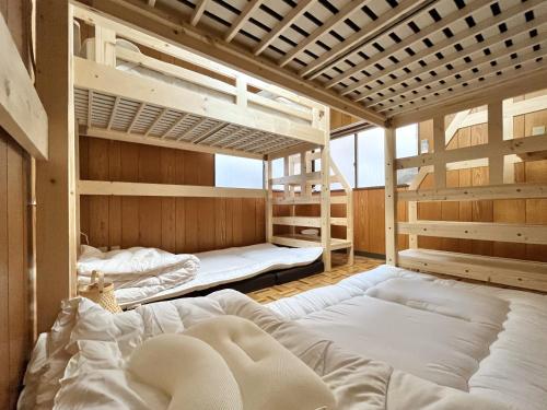 a room with three bunk beds in it at koto KAWASAKI in Kawasaki