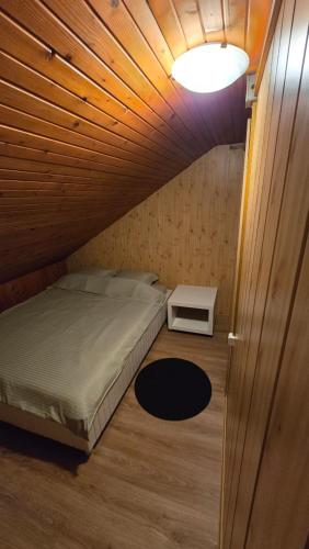 een kleine kamer met een bed en een tafel bij AVS Snagov Chalet in Snagov
