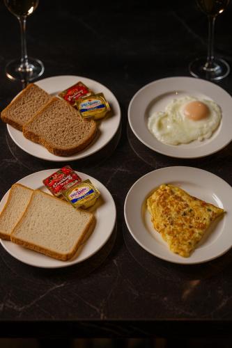 four plates of breakfast foods on a table at Elysium Tower Luxury Studio & One Bedroom Apartments Opposite Centaurus Mall Islamabad in Islamabad