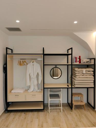 a display case with a white suit on a mannequin at Ammos Little Escape in Avdou