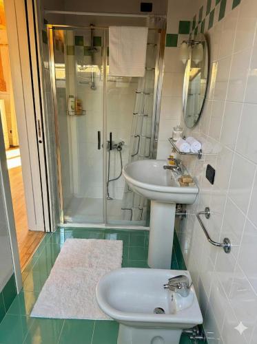 a bathroom with a sink and a shower at Marconi Deluxe - Attico a Due Passi dal Mare in Lido di Jesolo