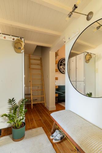 a living room with a mirror and a couch at Boogas House - Gdańsk in Gdańsk