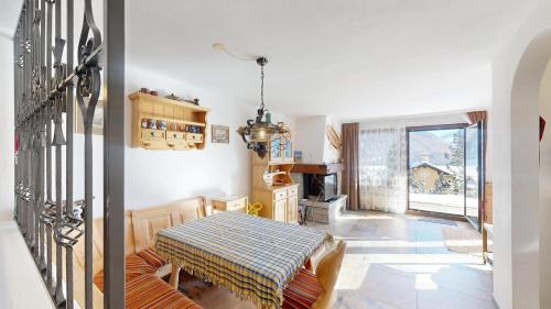 a living room with a table and a fireplace at Apartment Piz Argient in Samedan