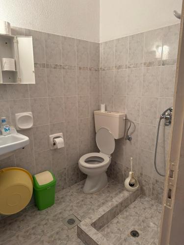 a bathroom with a toilet and a sink at Helena & Giorgio Rooms Cfu in Agios Georgios