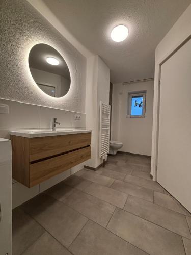 a bathroom with a sink and a mirror at Modern apartment with feel-good factor in Grafenwöhr