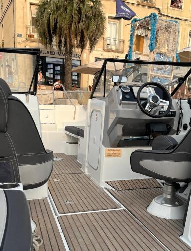a boat with a steering wheel and a dashboard at Le Bateau du Canal Sète in La Celle-sous-Gouzon