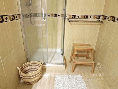een douche in een badkamer met een mand en een krukje bij Close To The Beach, With A Pool 224 in Las Lagunas Mijas