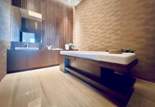 a bathroom with a large tub and a sink at Signature 2BR Apartment ARC100 Vasa Suite Surabaya City Centre with Balcony by Le Ciel Hospitality in Surabaya